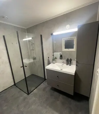 a bathroom with a sink and a shower at Newly renovated apartment for rent in Stjoerdal