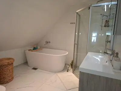 a bathroom with a tub and a shower and a sink at Close to the Airport and Trondheim in Malvik