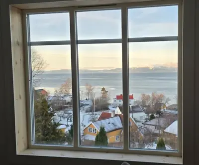 a window with a view of a town at Close to the Airport and Trondheim in Malvik