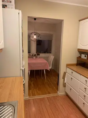 a kitchen with a table and a dining room at 2 bedrooms apartment in Trondheim