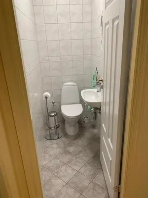 a small bathroom with a toilet and a sink at 2 bedrooms apartment in Trondheim
