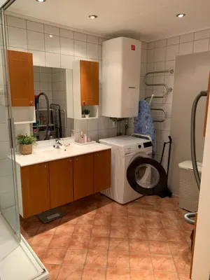 a bathroom with a washing machine and a washer at 2 bedrooms apartment in Trondheim
