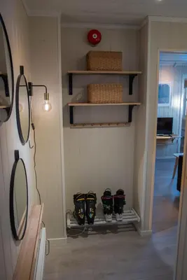 a room with three pairs of shoes on a wall at Alpinlandsbyen - Ski in - Ski out -Nr 34 in Hafjell