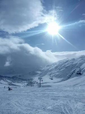 a sun is shining on a snow covered mountain at Mountain view 1 in Håra