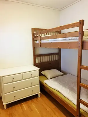 a bedroom with two bunk beds and a dresser at Mountain view 1 in Håra
