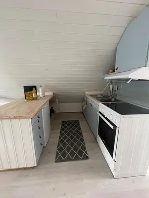 a small kitchen with a stove and a sink at Sjøro in Forland