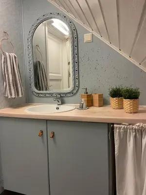 a bathroom with a sink and a mirror at Sjøro in Forland