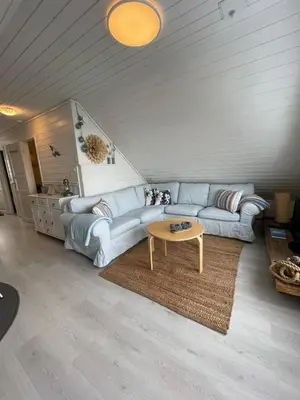 a living room with a couch and a coffee table at Sjøro in Forland
