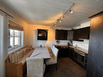 a kitchen with a table and a couch in it at Beitotind 1504 in Beitostøl