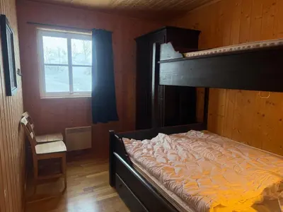 a bedroom with a bunk bed and a window at Beitotind 1504 in Beitostøl