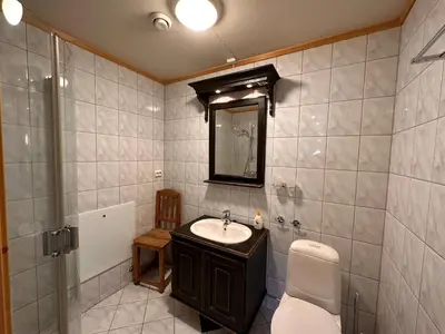 a bathroom with a sink and a toilet and a mirror at Beitotind 1504 in Beitostøl