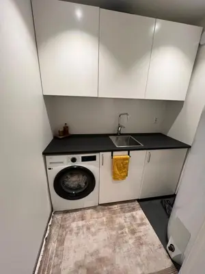 a small kitchen with a washing machine and a sink at Leilighet i trondheim in Trondheim