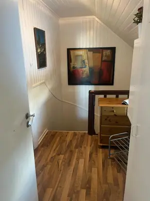 a room with a hallway with a wooden floor at Older Villa with large garden in Trondheim