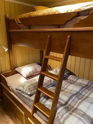 two bunk beds with a ladder in a room at Cozy cabin apartment, ski-in ski-out at Kvitfjell in Kvitfjell