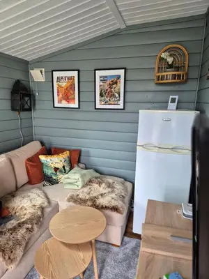 a living room with a couch and a refrigerator at Trysil Campingvogn Ski in-out in Trysil