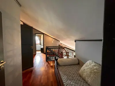 a hallway with a staircase and a stair case at Cozy Top-Floor Apartment With Fireplace And Sauna in Beitostøl
