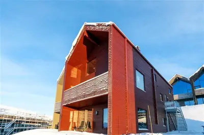 a red brick building with snow in front of it at Ski in-out - 3BR, 2 Bath Chalet apartment - Favn Hafjell in Hafjell