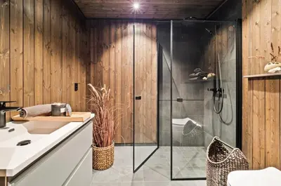 a bathroom with a glass shower and a sink at Ski in-out - 3BR, 2 Bath Chalet apartment - Favn Hafjell in Hafjell