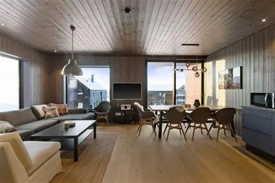 a living room with a couch and a table at Ski in-out - 3BR, 2 Bath Chalet apartment - Favn Hafjell in Hafjell