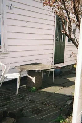 a bench sitting in front of a house at DINBNB Homes l Charming 2-Bedroom Home by the Sea Cozy in Bergen