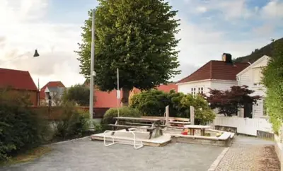 a group of picnic tables in a parking lot at DINBNB Homes l Charming 2-Bedroom Home by the Sea Cozy in Bergen