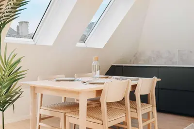 a dining room with a white table and chairs at 200m to Torgalmenningen & 20 sqm terrace in Bergen