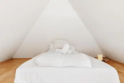 a white bed with two pillows in a room at 200m to Torgalmenningen & 20 sqm terrace in Bergen