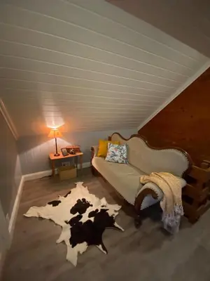 a bedroom with a bed with a cow cut up on the floor at Holiday house Vindafjord Norway in Ølsvågen