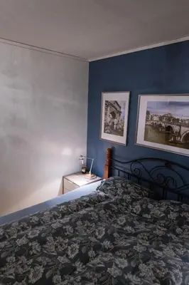 a bedroom with a bed and two pictures on the wall at Spacious house, close to Granåsen Ski Arena! 4 beds, 2 bathrooms, free parking in Trondheim