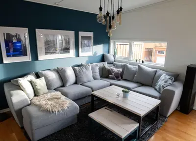 a living room with a couch and a table at Spacious house, close to Granåsen Ski Arena! 4 beds, 2 bathrooms, free parking in Trondheim