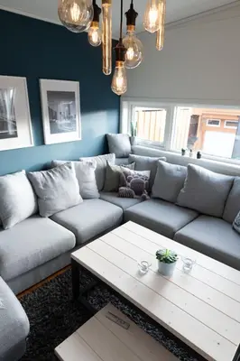a living room with a couch and a coffee table at Spacious house, close to Granåsen Ski Arena! 4 beds, 2 bathrooms, free parking in Trondheim