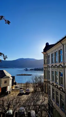 a building with a view of a body of water at Jugend City Retreat - Ålesund Apartment in Ålesund