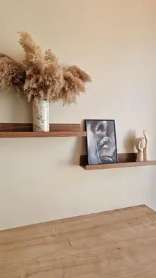 a shelf on a wall with two pictures on it at Jugend City Retreat - Ålesund Apartment in Ålesund