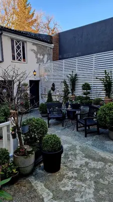 a courtyard with benches and potted plants and a building at Jugend City Retreat - Ålesund Apartment in Ålesund