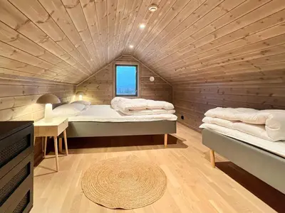 a bedroom with two beds and a wooden ceiling at 6 person holiday home in Averøya in Karvåg