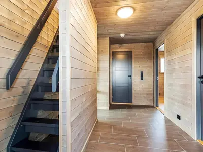 a hallway of a house with stairs and a door at 6 person holiday home in Averøya in Karvåg