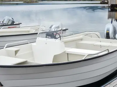 a white boat is docked in the water at 6 person holiday home in Averøya in Karvåg
