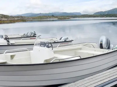 two boats docked at a dock on a lake at 6 person holiday home in Averøya in Karvåg