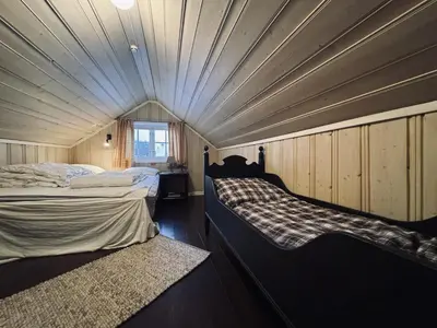 a small room with two beds and a window at Charming Cabin Near Hallingskarvet Ski Center, Cozy and Inviting! in Skoro