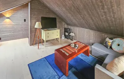 a living room with a couch and a tv at 3 Bedroom Cozy Home In Rendalen in Rendalen