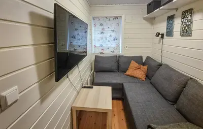 a living room with a couch and a tv at Gorgeous Home In Eivindvik With Wifi in Eivindvik