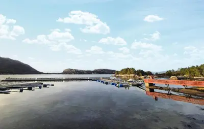 a large body of water with a dock and boats at Gorgeous Home In Eivindvik With Wifi in Eivindvik