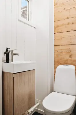 a bathroom with a sink and a toilet at Dinbnb Home - History meets Modern I 3-Story Bergen House in Bergen