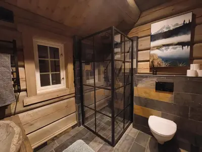 a bathroom with a shower and a toilet at Bånseterlodgen in Favang