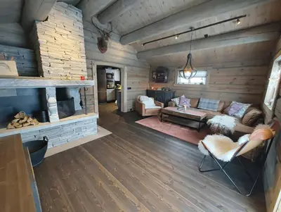 a living room with a couch and a fireplace at Bånseterlodgen in Favang