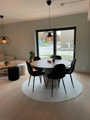 a dining room with a table and chairs in a living room at New Powerhouse apartment in Lade in Trondheim in Trondheim