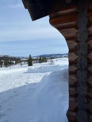 a view from a log cabin in the snow at Kvenahytta in Markegardlian