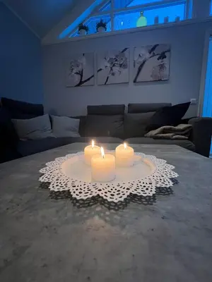 two candles on a table in a living room at Amazing home in the heart of Nordfjordeid in Nordfjordeid