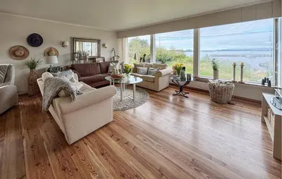 a living room filled with furniture and a large window at 4 Bedroom Gorgeous Home In Atløy in Herland