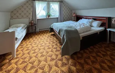 a bedroom with two beds and a window at 4 Bedroom Gorgeous Home In Atløy in Herland